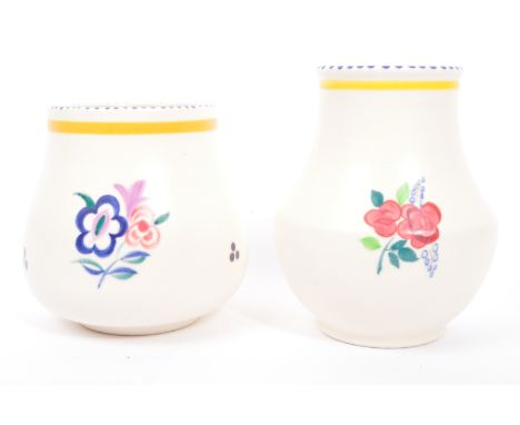 Two retro vintage 20th Century Poole pottery vases. With painted decoration to body, floral polychrome design on circular bas