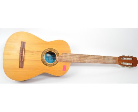 A retro vintage 20th century Spanish B M Clasico acoustic guitar. It measures approx. 97cm long.