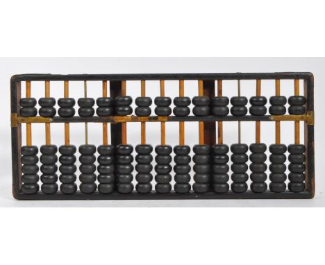 An early 20th century circa. 1920's Chinese abacus suan-pan calculator having ebonised wooden beaded with brass mounts to fra