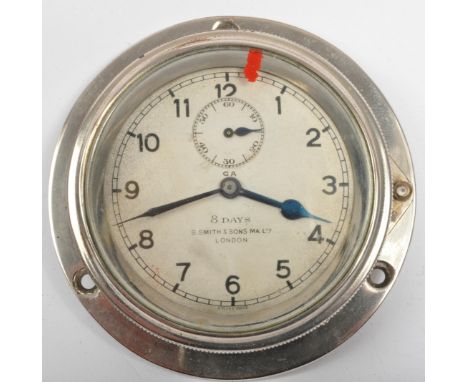 A vintage 20th Century S. Smith &amp; Sons London 8 Days car clock. The clock having a round face with arabic numerals to the