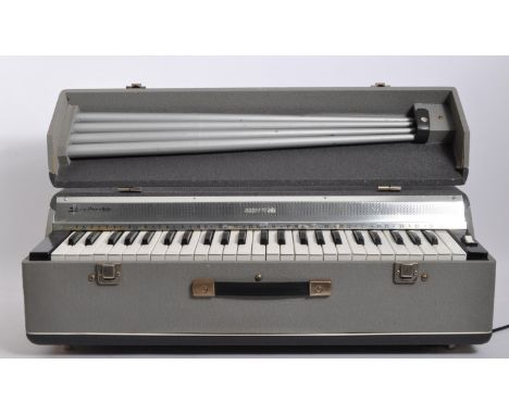 J. Busilacchio - A 1960's vintage Italian cased electric organ / piano, the case having grey vinyl exterior and raised on det