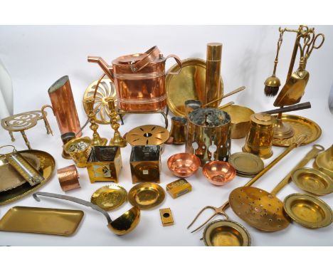 A large collection of 19th century Victorian and later brass and copper to include trays, fireside set, trivet, watering can,