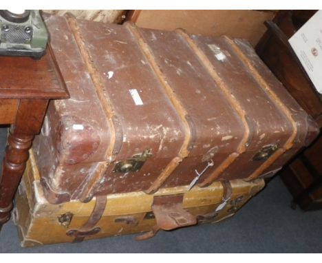 A vintage cabin trunk and a similar wooden bound example