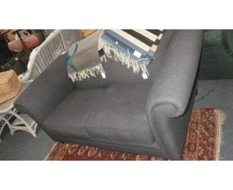 A modern two seater sofa in blue material on turned legs with brass castors 66" wide (approx) 