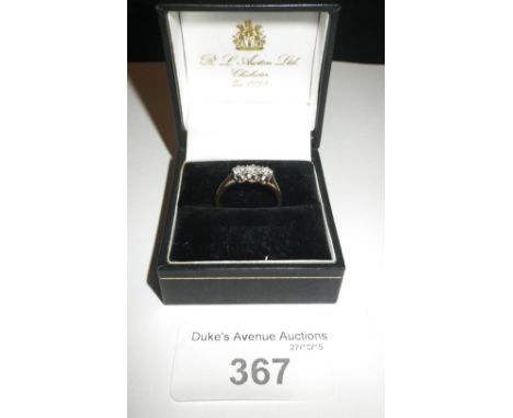 A ladies yellow gold three stone diamond dress ring