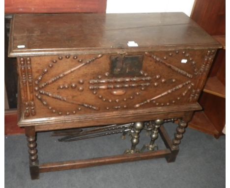 An 18th century and later oak chest with applied decoration on a bobbin turned stand 33" wide (approx)