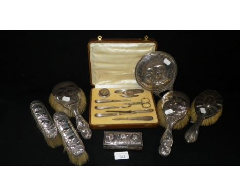 A silver mounted dressing table set comprising four brushes, a mirror and a trinket box, one other silver mounted brush and a