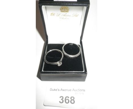 A white gold single stone diamond ring and a white gold wedding band (2)