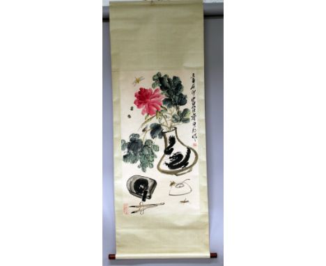 A CHINESE HANGING SCROLL PAINTING ON PAPER, in the manner of Qi Baishi, within a silk surround, depicting a vase of flowers w