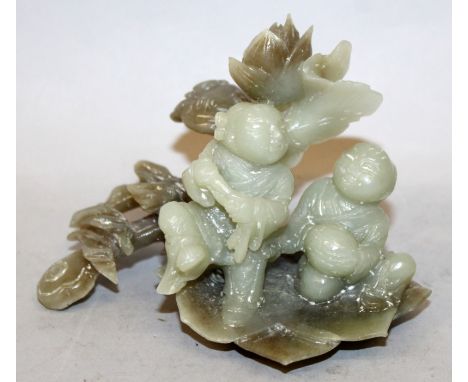 A CHINESE JADE-LIKE HARDSTONE MODEL OF THE HE HE ERXIAN, the two boys on a lotus leaf beside a ruyi sceptre, 5in wide & 3.7in