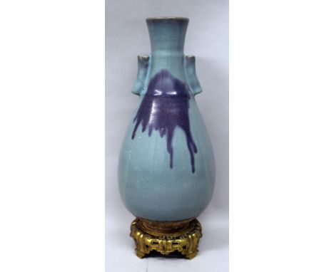 A LARGE CHINESE JUNYAO CERAMIC ARROW VASE, together with a fixed gilt ormolu stand, the sides of the pear-form body applied w