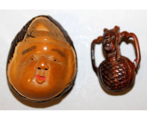 A SIGNED JAPANESE TAGUA NUT NETSUKE OF DAIKOKU, the deity's face with smiling expression, the underside with an engraved sign