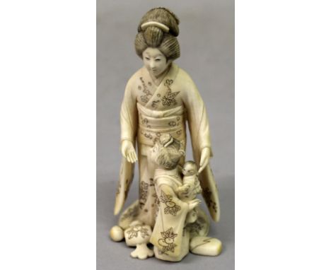 A SIGNED JAPANESE MEIJI PERIOD IVORY OKIMONO GROUP, of a geisha in the company of a young girl who bears a baby on her back, 