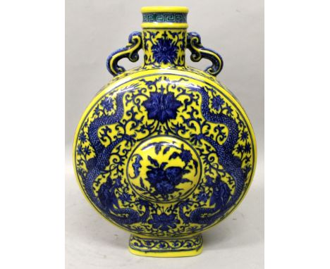 A GOOD QUALITY CHINESE BLUE & WHITE YELLOW GROUND PORCELAIN MOON FLASK, each side with a domed panel of peach enclosed by dra