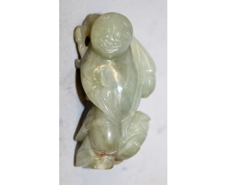 A SMALL 19TH CENTURY CHINESE CELADON GREEN JADE CARVING OF A DANCING BOY, his shoulders carved in relief with a bat, 2.25in h