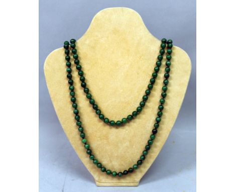 A LONG CHINESE SPINACH GREEN JADE-LIKE NECKLACE, composed of spherical beads, approx. 54.5in long.