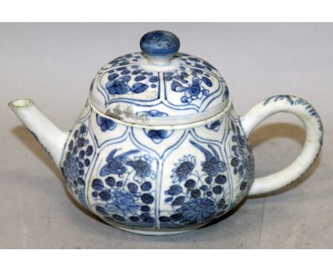 A GOOD CHINESE KANGXI PERIOD BLUE & WHITE SHIPWRECK TEAPOT & COVER, circa 1700, with a variety of barbed floral panels, some 