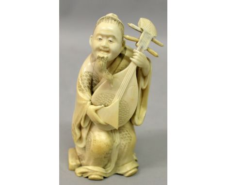 A SIGNED JAPANESE MEIJI PERIOD IVORY OKIMONO OF A MAN PLAYING A LUTE, the man seated in patterned robes on an oval seat, the 