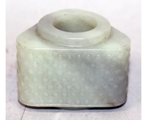 A CHINESE CELADON JADE CONG, of archaic design and triangular section with rounded corners, the exterior with a design of rai