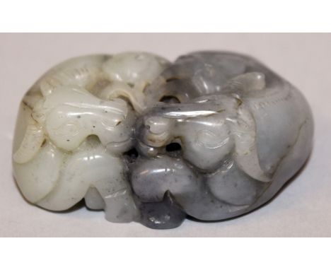 A CHINESE GREY & CELADON JADE-LIKE GROUP OF WATER BUFFALO, the two recumbent animals facing each other with a sprig of lingzh