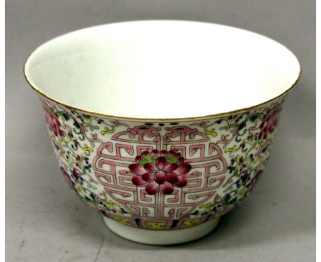 A CHINESE FAMILLE ROSE PORCELAIN BOWL, the sides decorated with a repeated design of lotus reserved against an auspicious arc