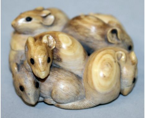 A GOOD QUALITY SIGNED NETSUKE OF A GROUP OF RATS, their eyes inlaid, 2in square at widest points.