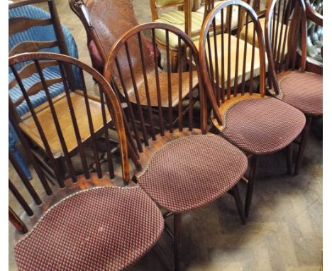 A set of 4 stick back Windsor dining chairs with upholstered seat pads