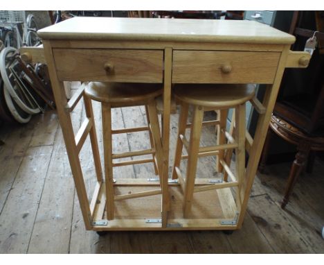 A light wood table on legs with 2 matching stools under