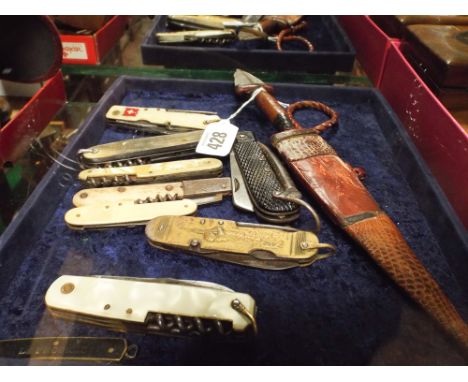 A collection of 19th century pen knives, military Swiss army knife together with an African dagger in its leather covered sca