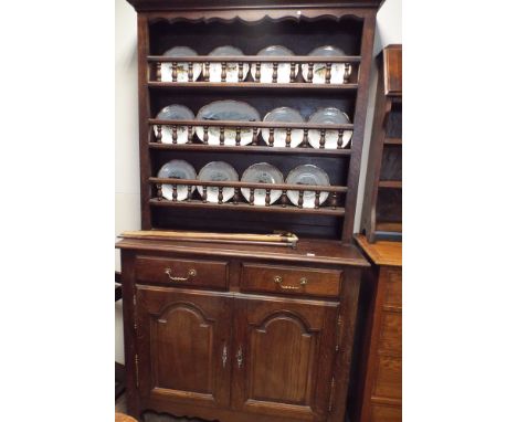 A 4' French oak dresser with shelf back and bobbin turned fronts on drawer and cupboard base