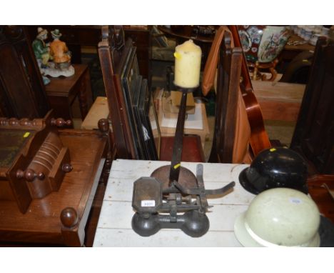 A set of kitchen scales and a candle holder