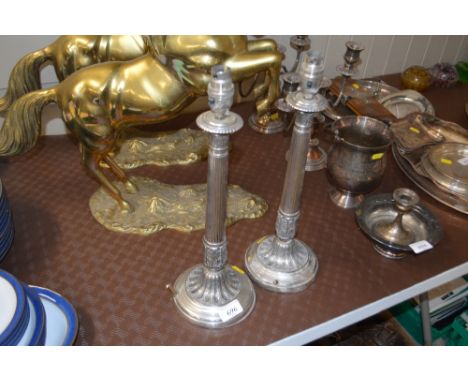 A pair of silver plated table lamps sold as collector's item 