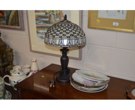A Tiffany style table lamp and various decorative plates