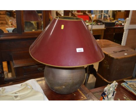 A brass table lamp with shade