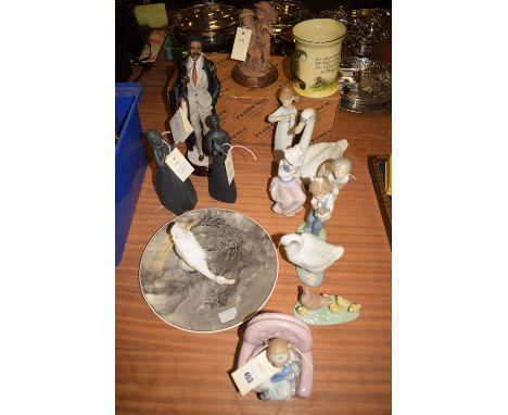 Six Spanish Nao ceramic ornaments; three Spanish Lladro ornaments modelled as a girl playing a musical instrument, a girl in 