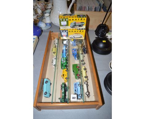 A collection of eighteen die-cast model vehicles, by Vanguards, comprising: cars, commercials and lorries, all mounted in a g