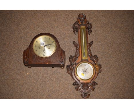 A aneroid barometer in carved oak case, by Negretti and Lambral, of London; and a 1930's oak mantel clock, by Ingerscott.
