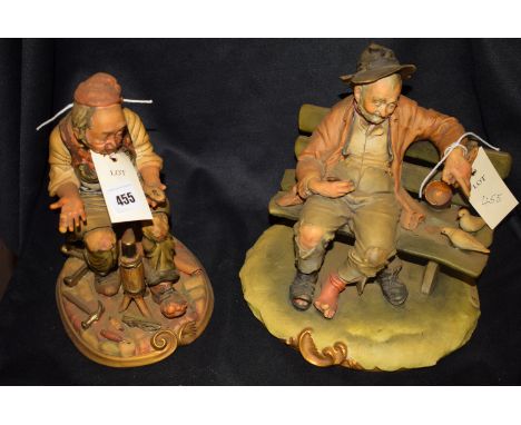 A Neapolitan ceramic ornament modelled as a cobbler; together with another as a hobo sitting on a bench.  (2)