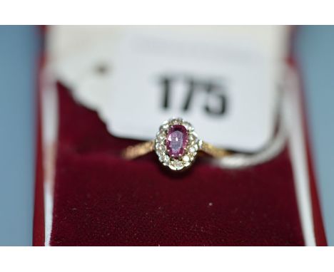 A ruby and diamond cluster ring on 9ct. yellow gold shank, ring size L.
