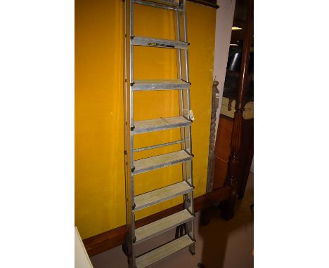 An eight tread folding aluminium step ladder.