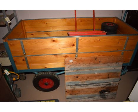 A pine sided yard cart/ garden trolley, rectangular with deep sides; four other tyres; a Wolf tools garden spreader; and wate