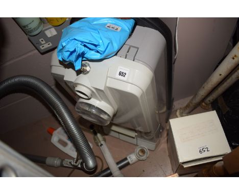 A Karcher Model 555C floor washing machine with attachments and bottles of fluid.