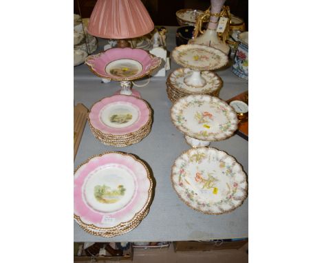 A thirteen-piece Continental ceramic dessert service, decorated central landscape scenes on white ground with pink and gilt b