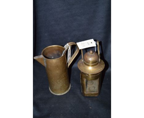 A vintage brass hand lamp by L.S. Co. Ltd., 1943; together with a brass trench art jug made from a First World War 18lb shell