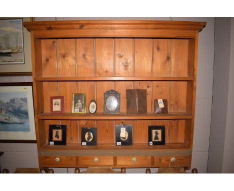 A modern pine wall hanging three-tier delft rack, fitted four shallow drawers in the base with ceramic handles, 48in. wide ov