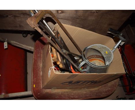 A red painted metal wheelbarrow; and a box containing various garden hand tools.