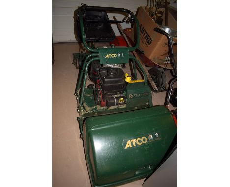 An Atco Royale 24E 1/C petrol driven cylinder lawn mower, 24in. cutting blade, grass box and ride-on roller.