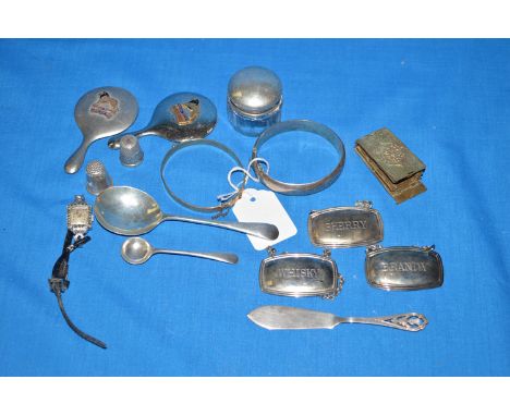 Silver and other metal items, to include; a miniature hand mirror; decanter labels; a bangle; a watch; and a thimble; etc.