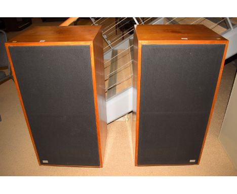 A large pair of IMF transmission-line speaker cabinets in mahogany finish.
