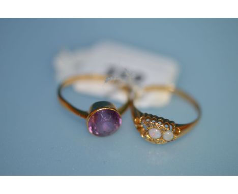 An amethyst ring on 9ct. gold shank; together with an opal and diamond ring (missing one opal) on 18ct. gold shank.